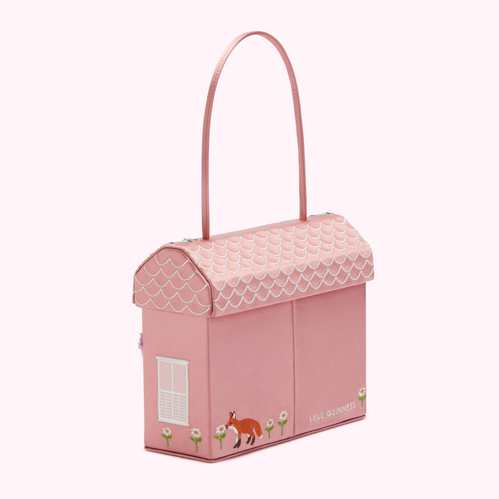 Pink house-shaped handbag with fox and flower embroidery, designed by Lulu Guinness.