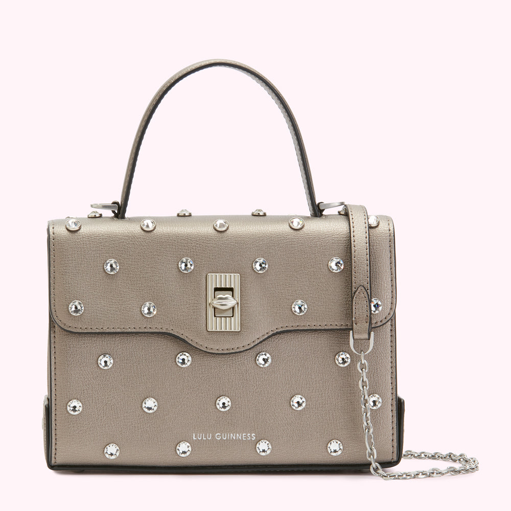 A silver Lulu Guinness satchel handbag adorned with clear crystals.
