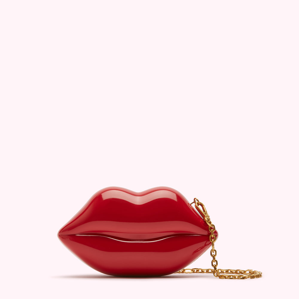 Red lip-shaped clutch with gold chain.
