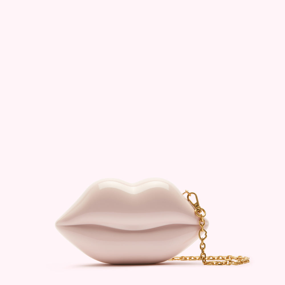 Pale pink lips-shaped clutch with gold chain.
