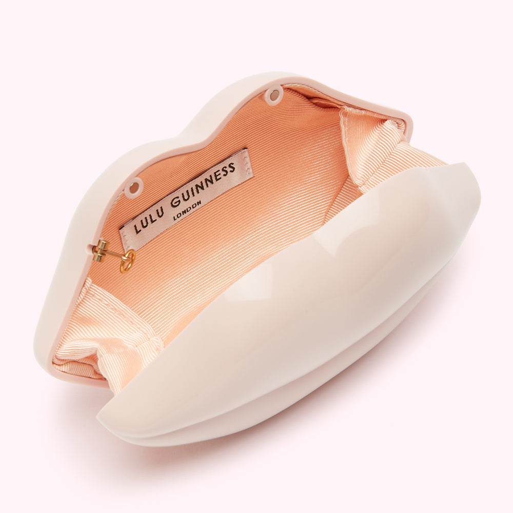 Open blush pink Lulu Guinness lip-shaped clutch with peach satin lining.
