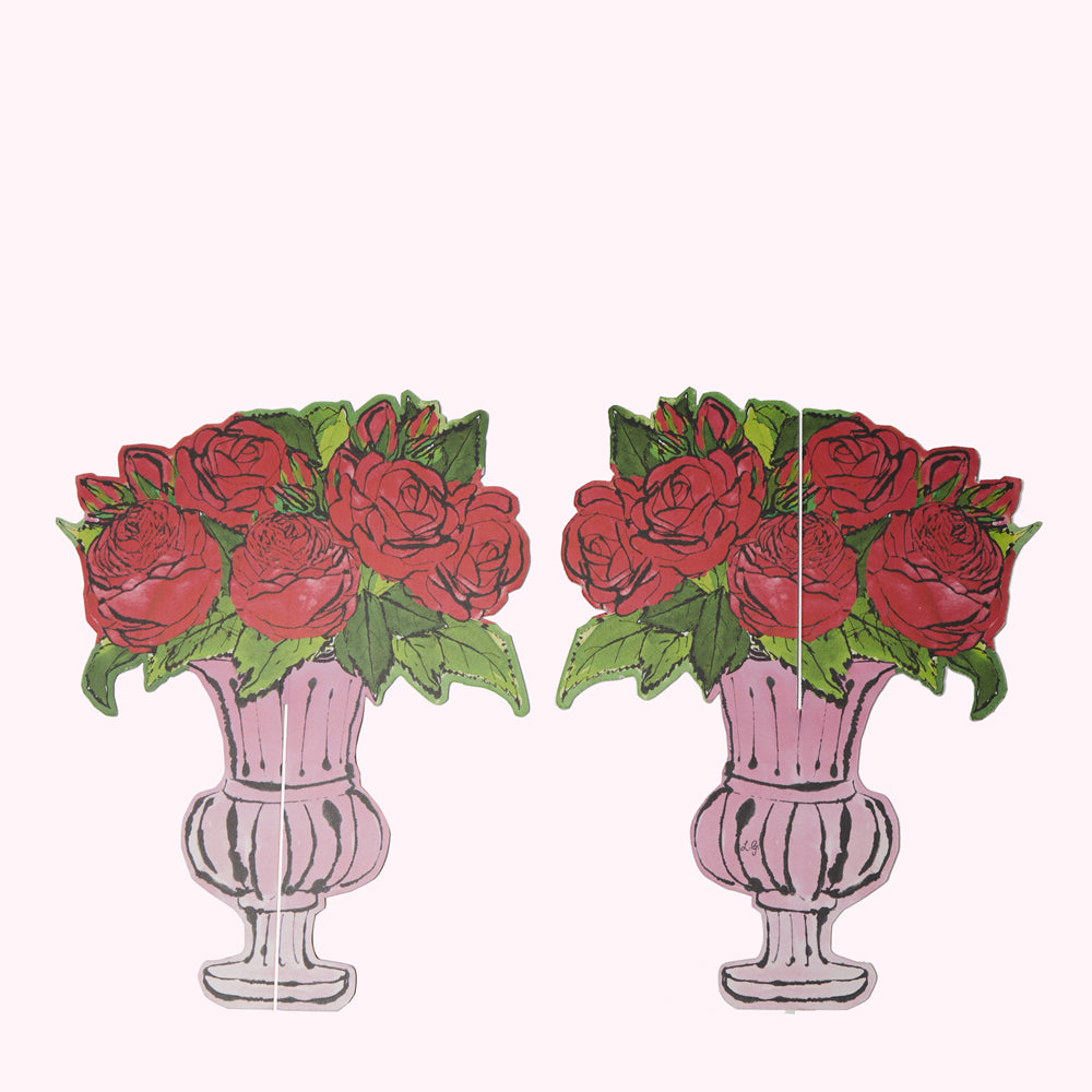 Two pink vases filled with red roses, on a white background.
