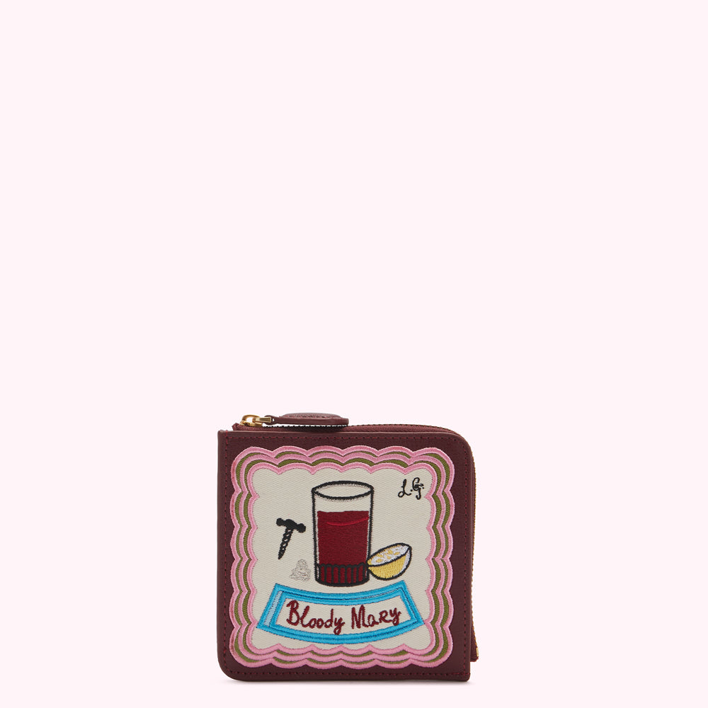 Burgundy leather zip-around wallet with embroidered Bloody Mary cocktail design.
