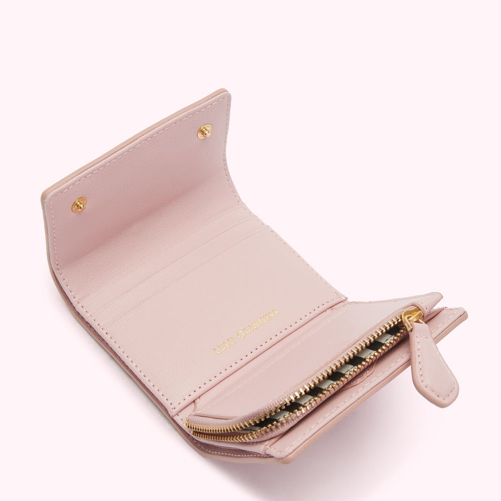 Pink leather wallet open to reveal interior compartments and gold zipper.