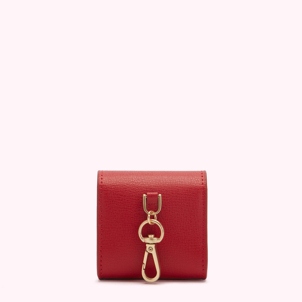 Red leather key holder with gold clasp.
