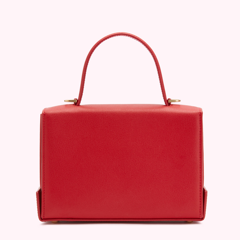 Red leather handbag with a top handle and gold hardware.
