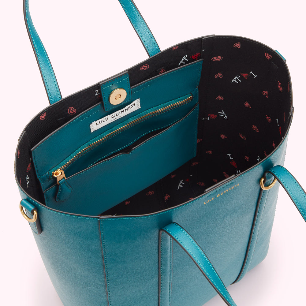 Teal Lulu Guinness tote bag with black and red heart print lining.