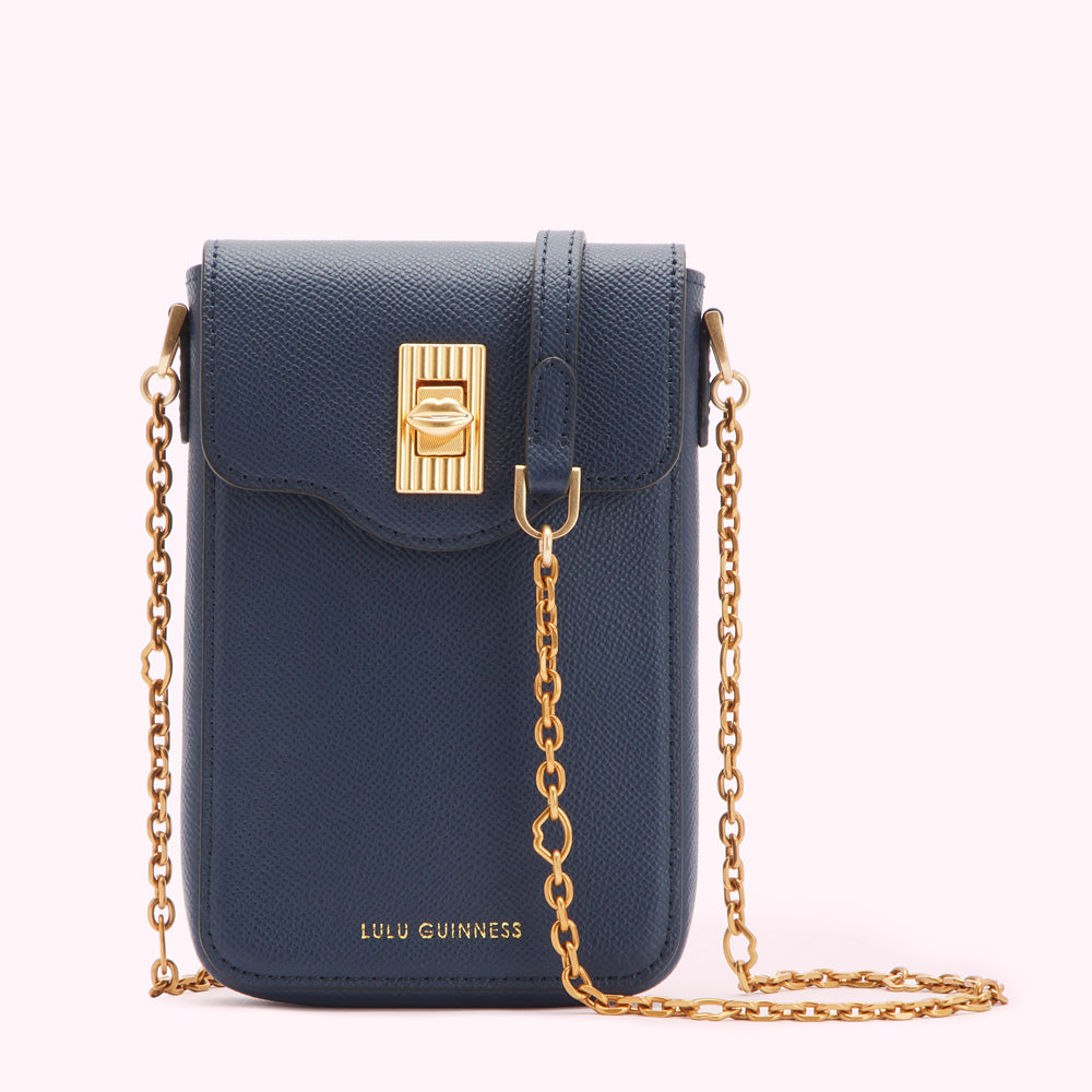 Navy blue Lulu Guinness crossbody bag with gold chain strap and clasp.
