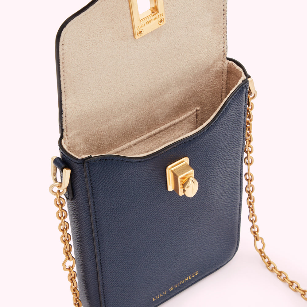 Open navy blue Lulu Guinness crossbody bag with gold chain strap and clasp.