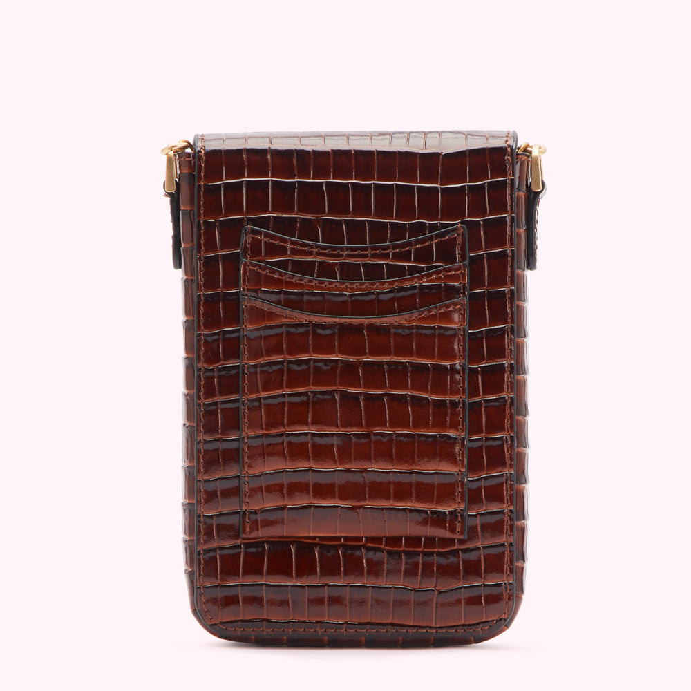 Brown crocodile-embossed leather crossbody bag with a back pocket.

