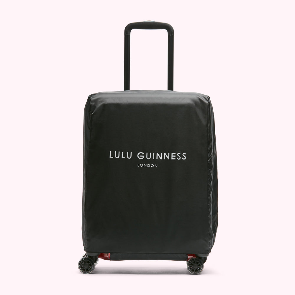 Black Lulu Guinness London luggage cover on a wheeled suitcase.
