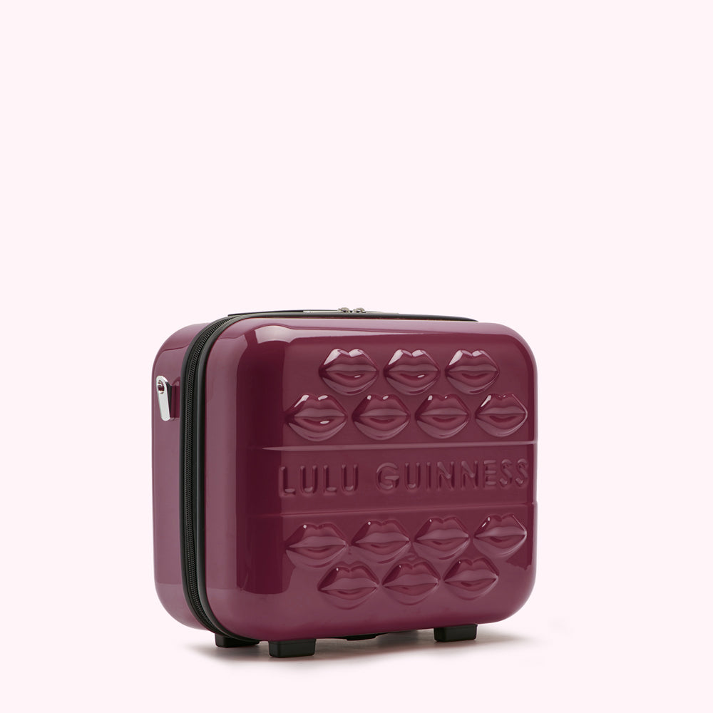 Burgundy Lulu Guinness makeup case with lips design.