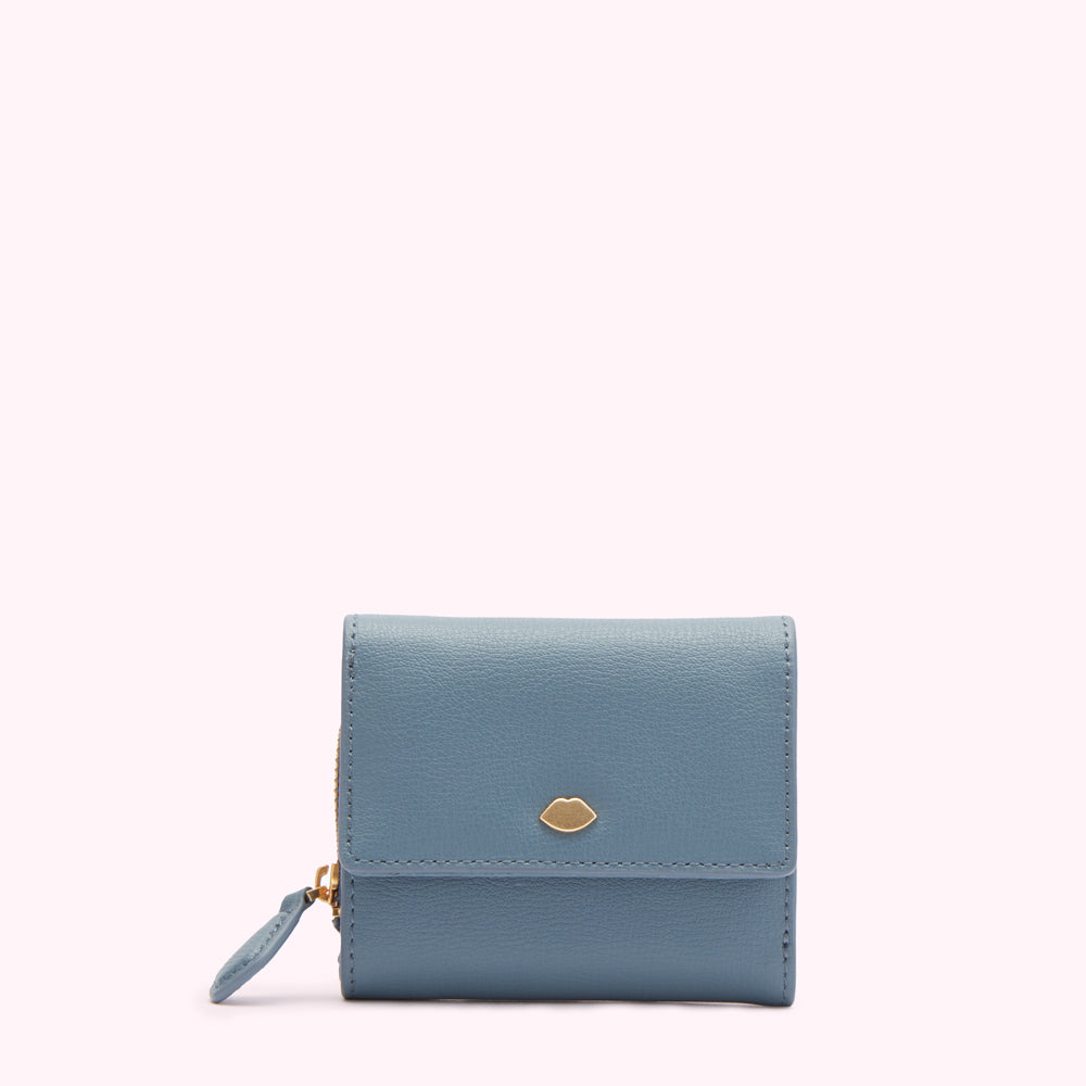 A small, light blue leather wallet with a gold lip-shaped emblem on a white background.
