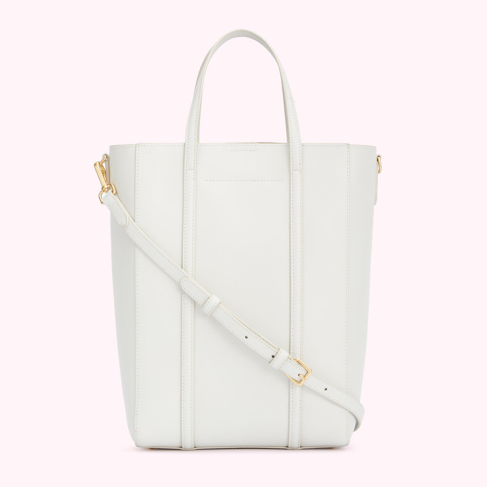 White leather tote bag with gold hardware and an adjustable shoulder strap.

