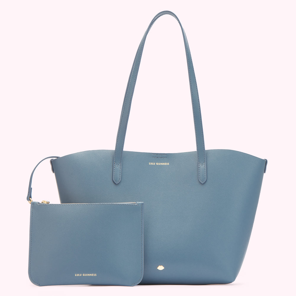 A light blue Lulu Guinness tote bag and matching zip pouch on a white background.
