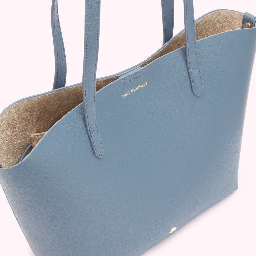 A light blue Lulu Guinness tote bag with beige suede interior.