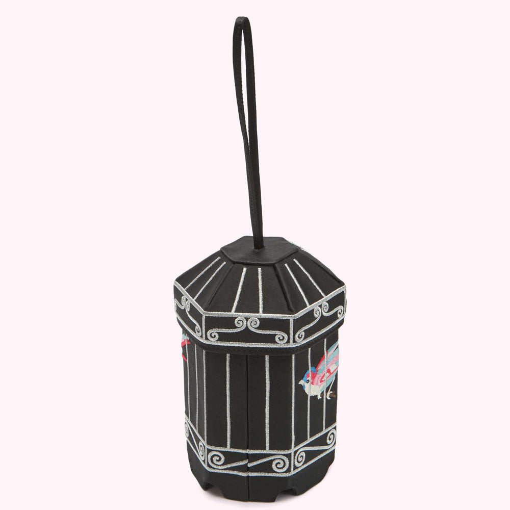 Black octagonal box with silver detailing and embroidered birds, hanging from a black cord.
