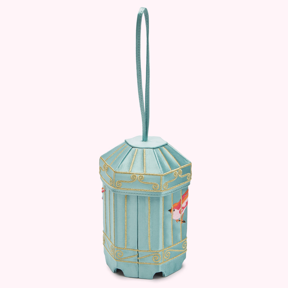 A pale blue birdcage-shaped box with gold detailing and small embroidered birds hangs from a satin strap.
