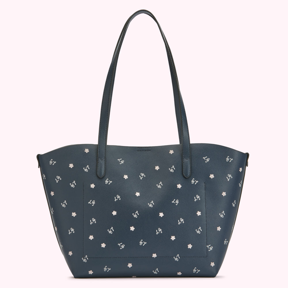 Dark blue tote bag with small white floral pattern.