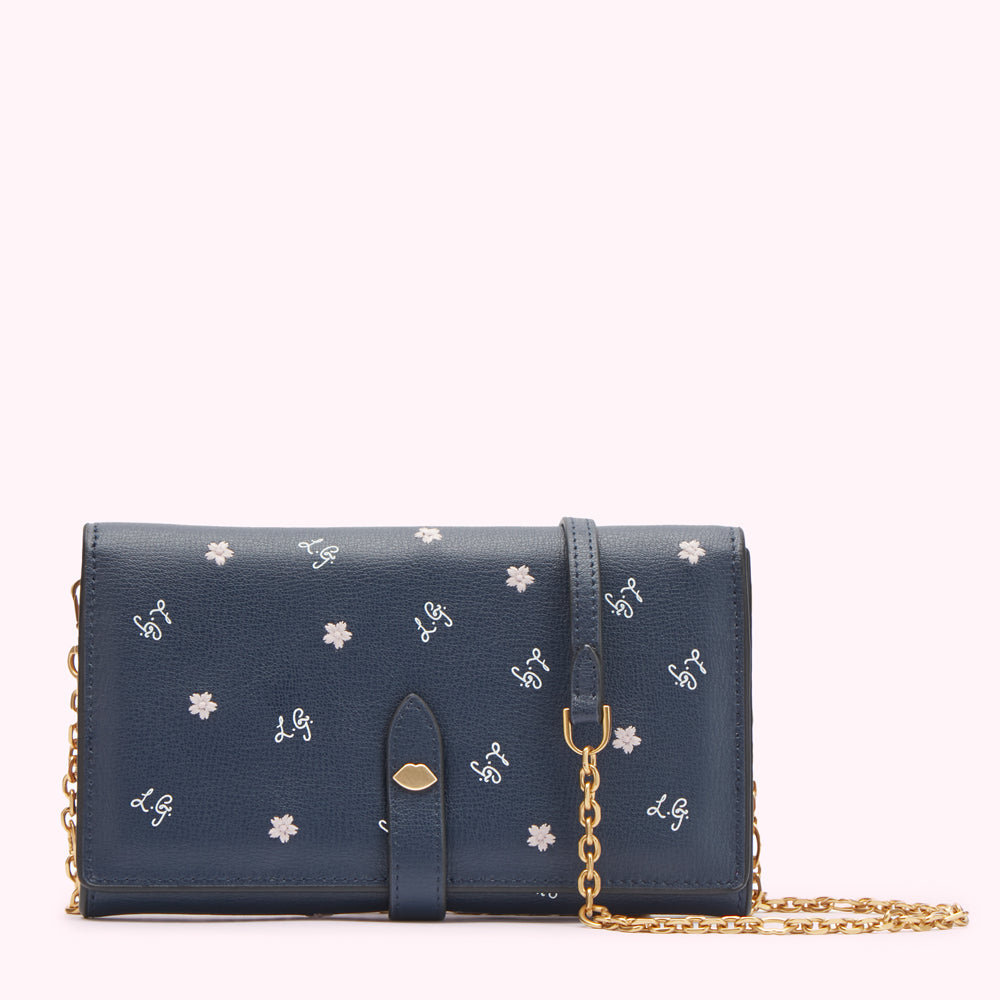 Navy blue leather wallet on chain with white embroidered flowers and logo.
