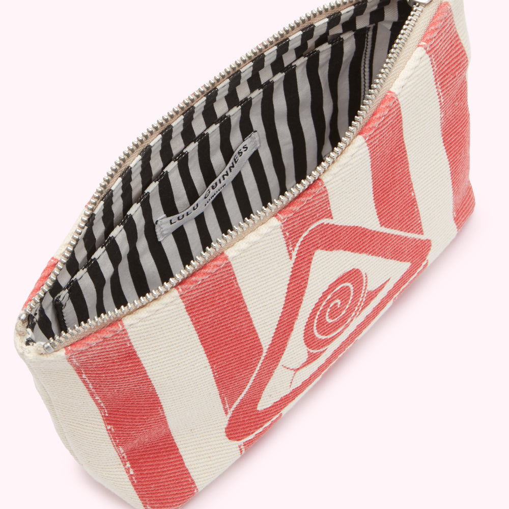 Open Lulu Guinness pouch with red stripes and a red eye design on an off-white background. The lining is black and white striped.
