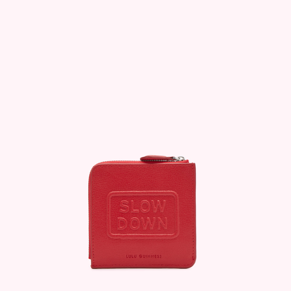 Red leather zip-around wallet with "Slow Down" embossed on the front.

