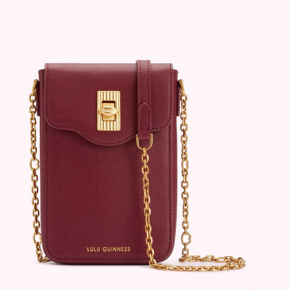 Burgundy Lulu Guinness crossbody bag with gold chain strap and clasp.