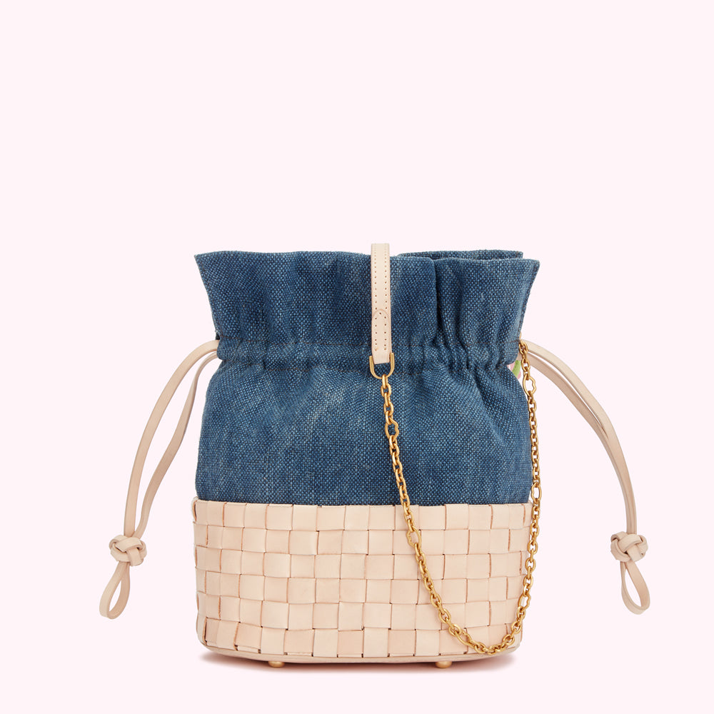 Blue denim and tan leather bucket bag with gold chain strap.
