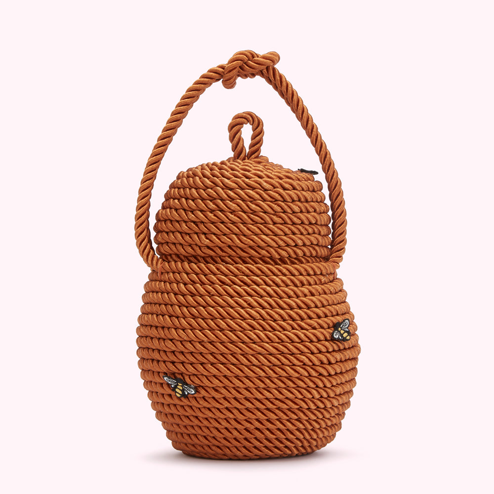 Brown rope-textured handbag with small bee embellishments.
