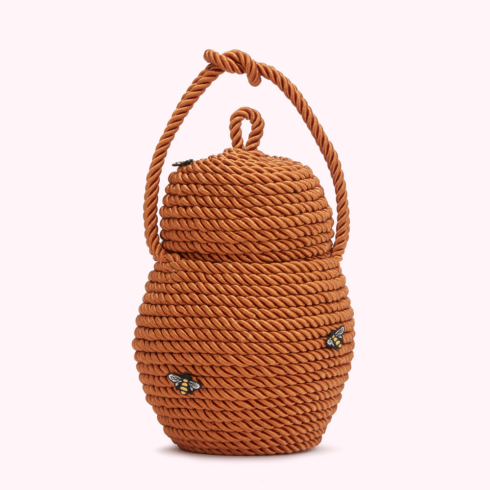 Brown rope-textured handbag shaped like a beehive with small bee accents.
