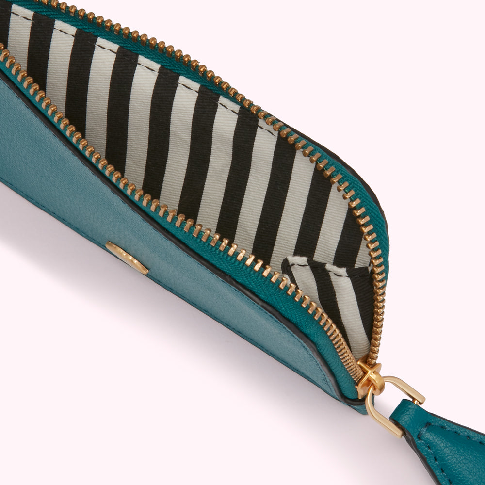 Teal zipper pouch open to reveal black and white striped lining.