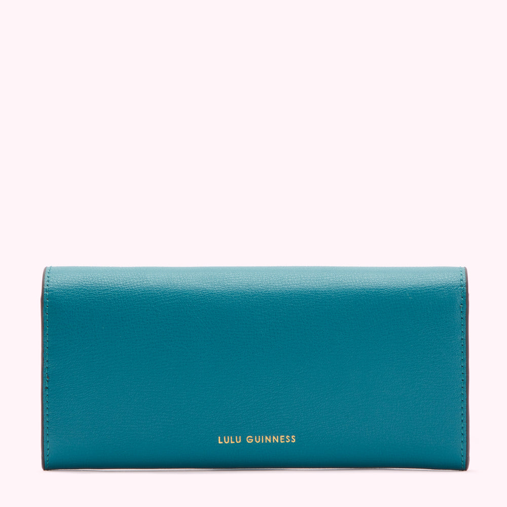Teal leather Lulu Guinness wallet on white background.
