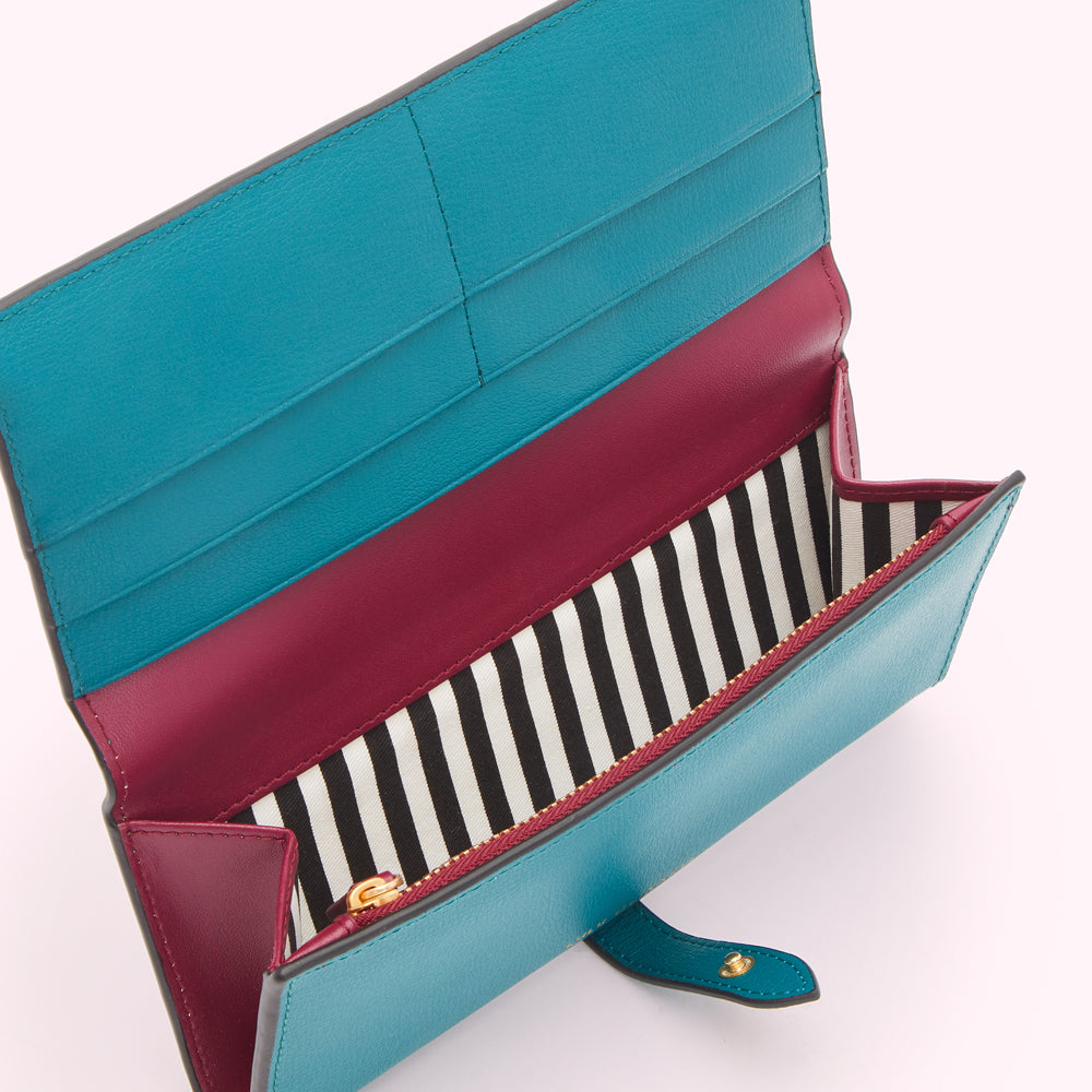 Open teal and burgundy leather wallet with black and white striped lining.
