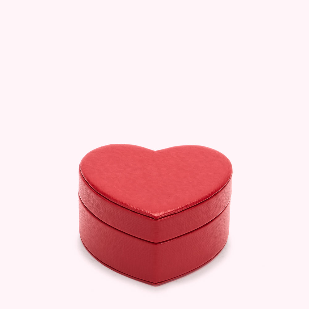 Red heart-shaped jewellery box on white background.
