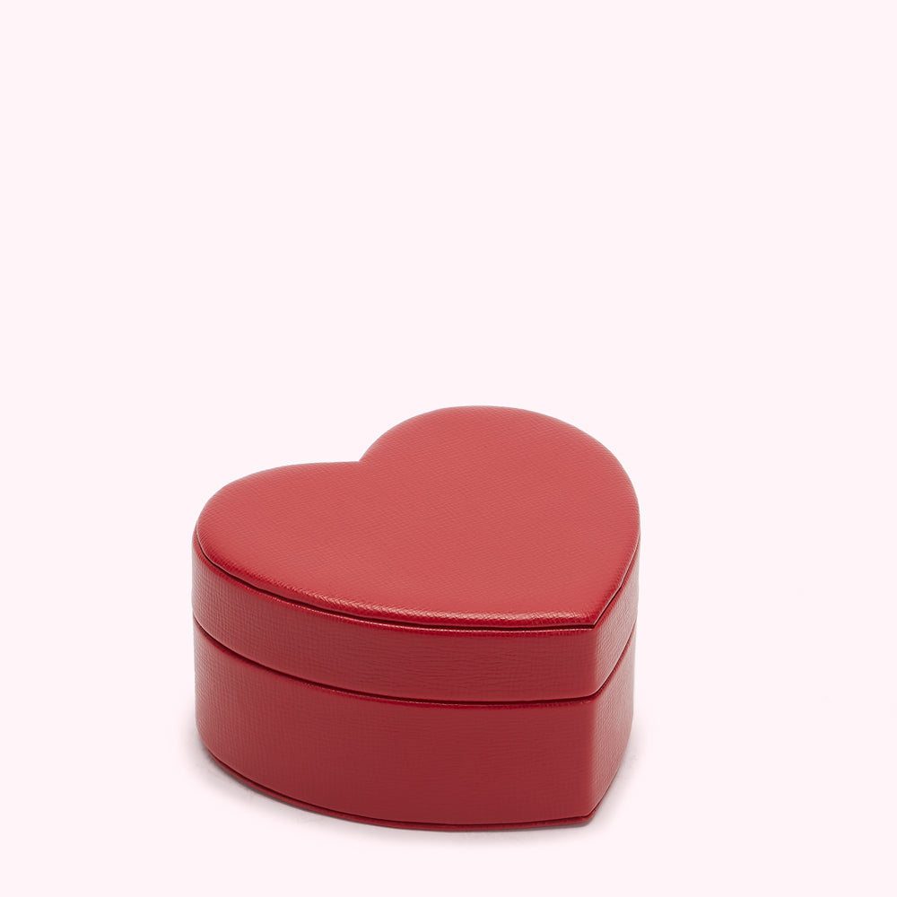 Red heart-shaped jewellery box on white background.

