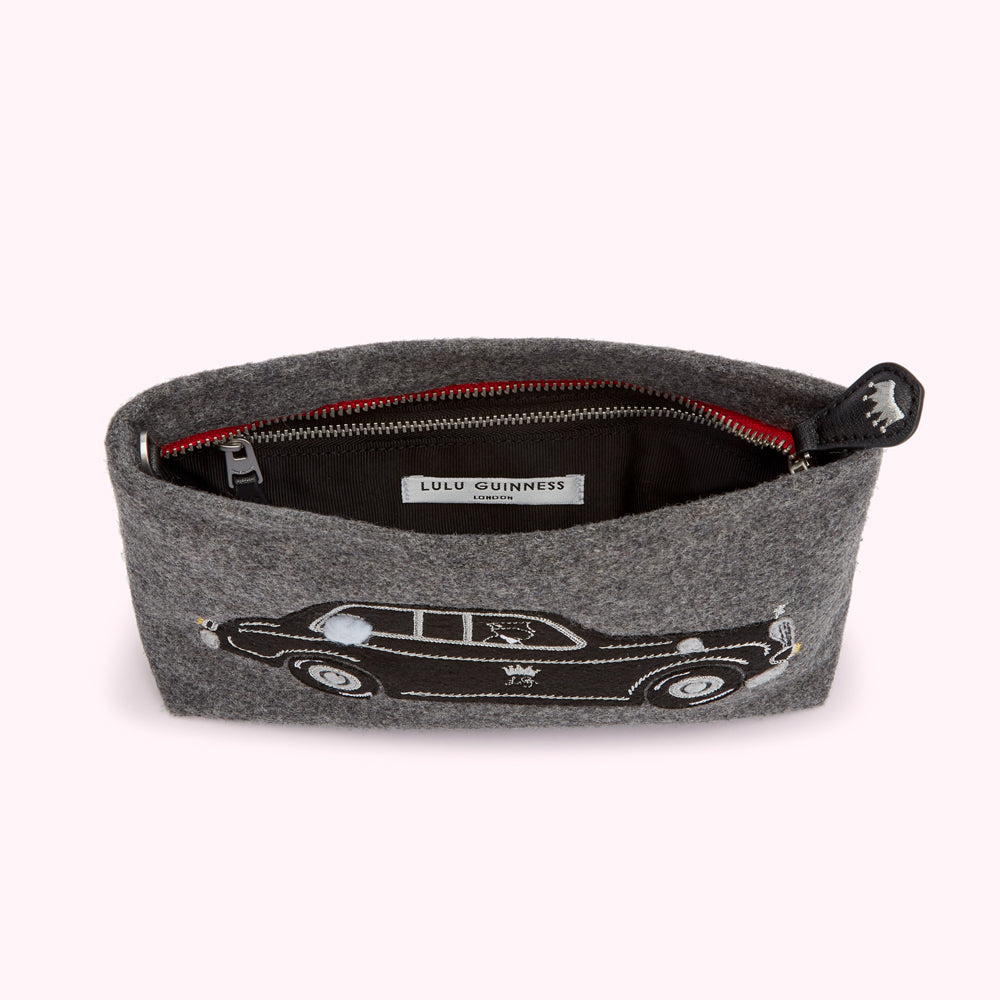 Grey felt clutch with embroidered car and red zipper. Lulu Guinness label visible inside.
