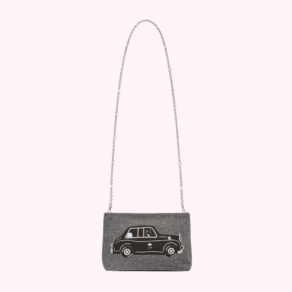 Grey felt crossbody bag with a black embroidered taxi cab design and a silver chain strap.
