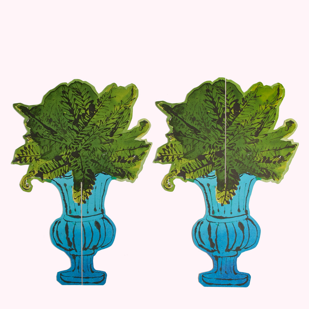 Two vibrant teal urns overflowing with lush, stylized green ferns against a white background.
