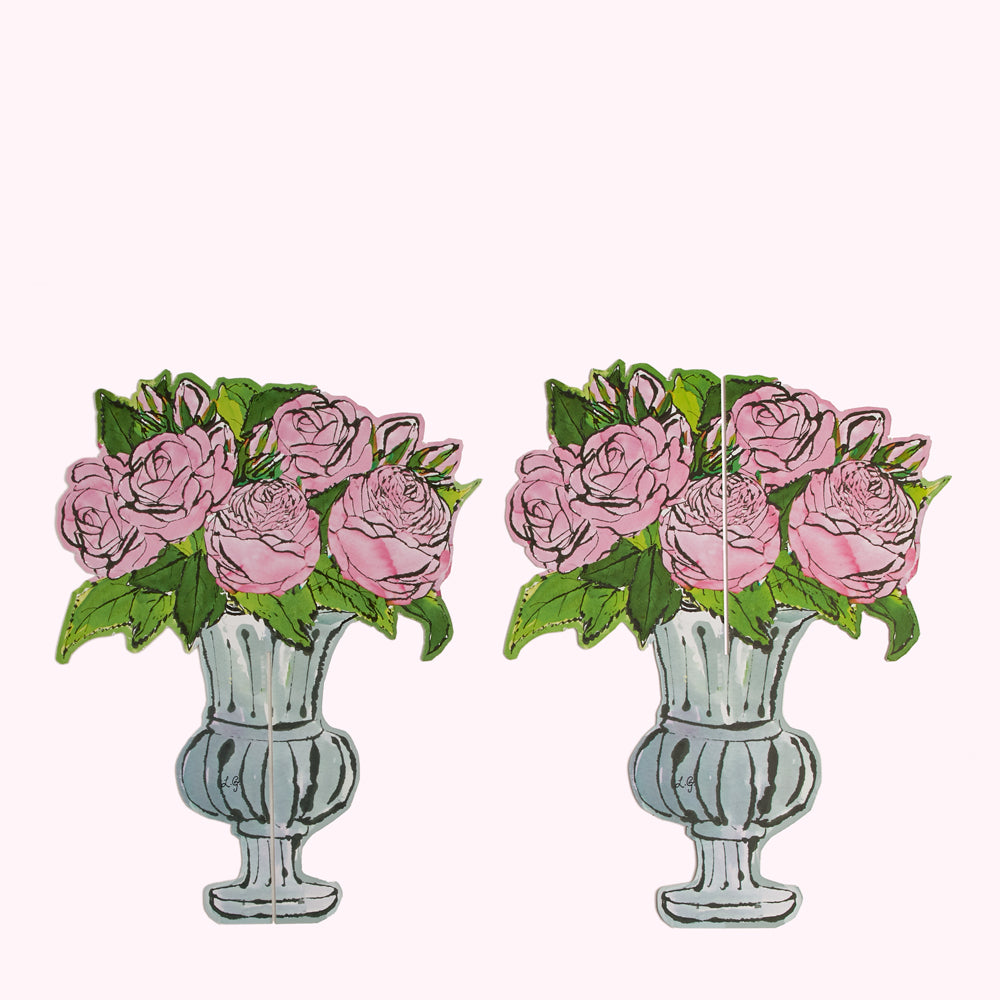 Two illustrations of pink roses in urn-shaped vases against a white background.