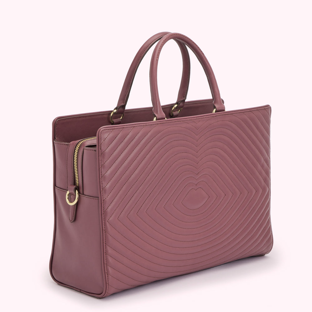 A mauve quilted leather tote bag with two top handles and gold-toned hardware.
