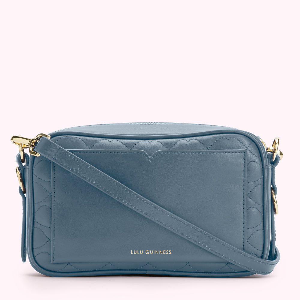 A blue quilted Lulu Guinness crossbody bag with gold hardware.
