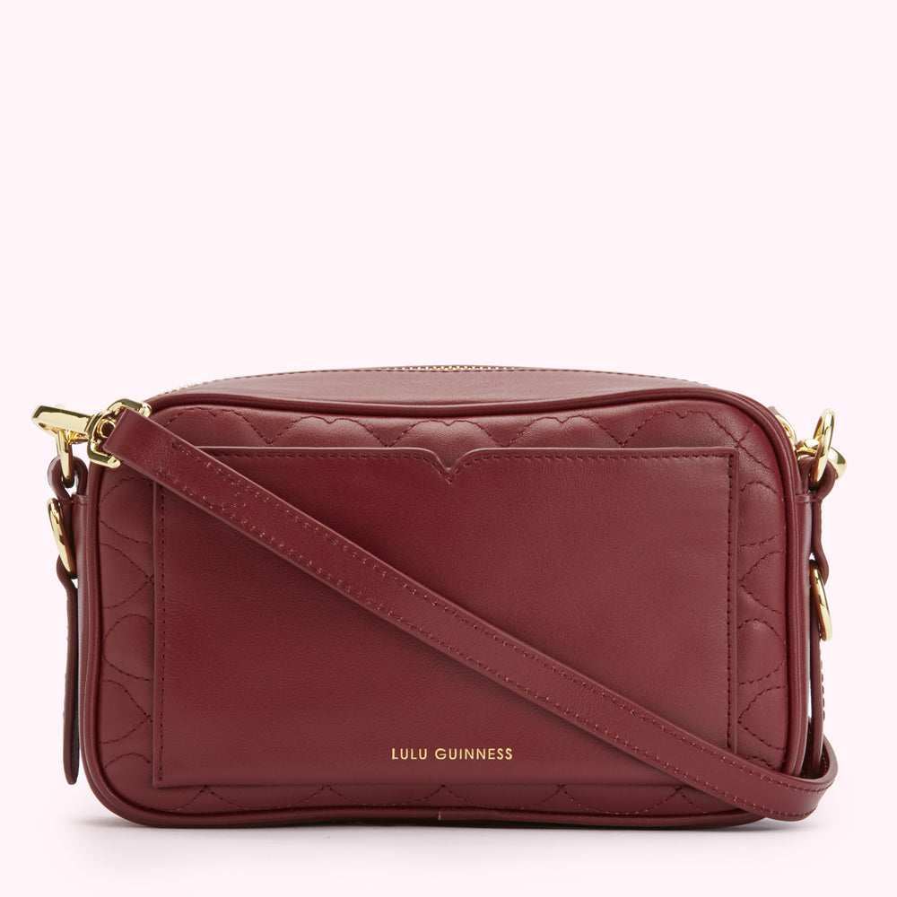 Burgundy quilted crossbody bag with gold hardware and Lulu Guinness logo.
