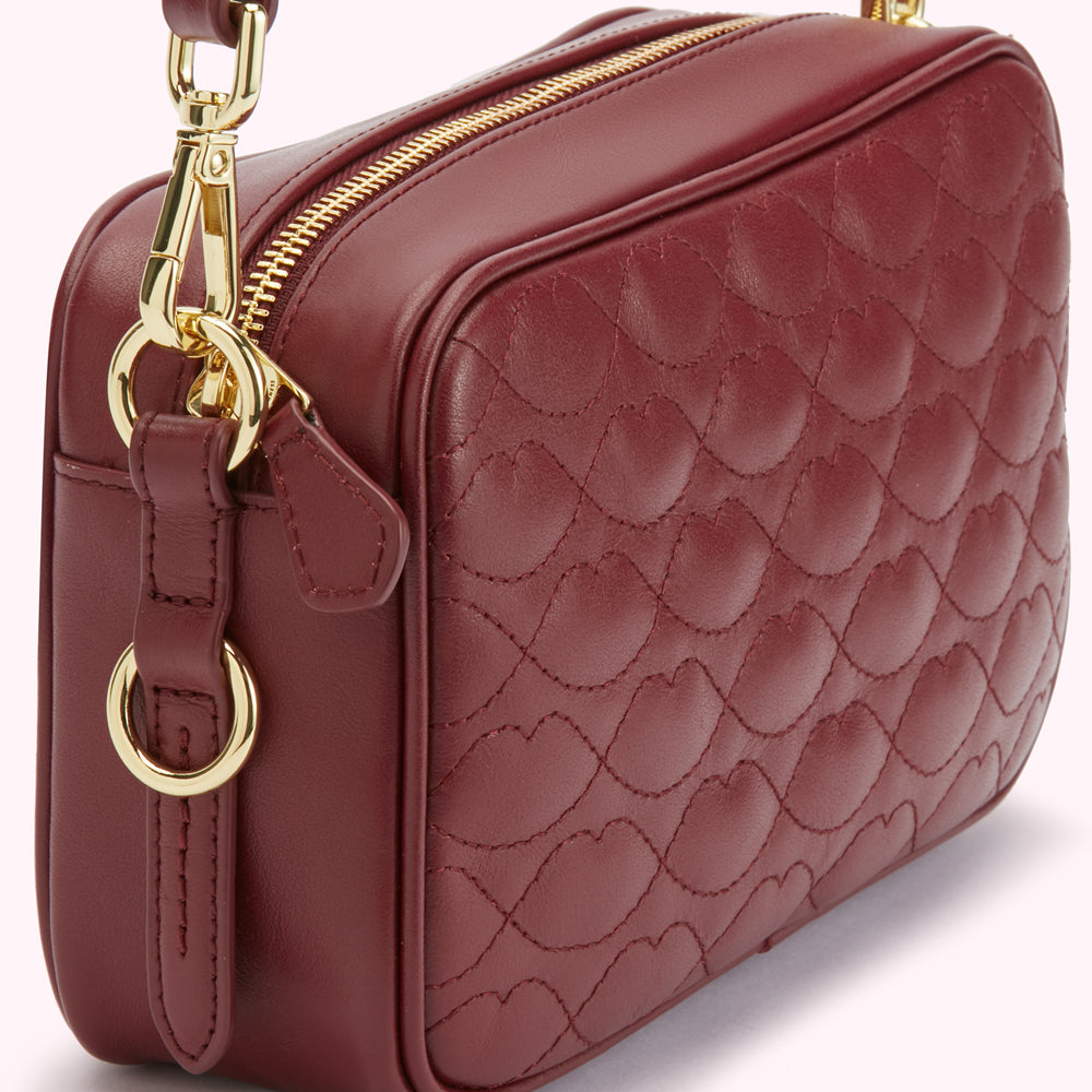 Burgundy quilted leather crossbody bag with gold-toned hardware.
