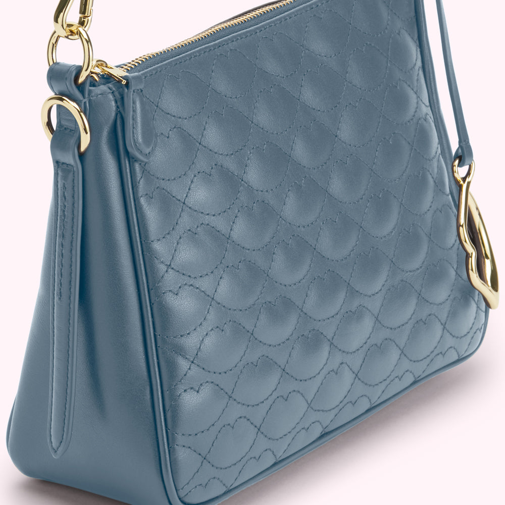 Dusty blue quilted leather crossbody bag with gold-tone hardware.

