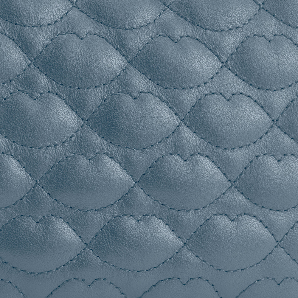 Close-up of quilted blue leather texture.
