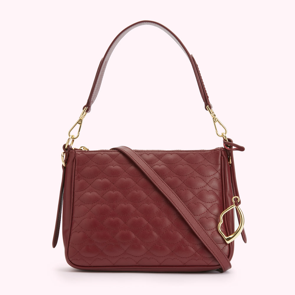 Burgundy quilted leather crossbody bag with gold-toned hardware.
