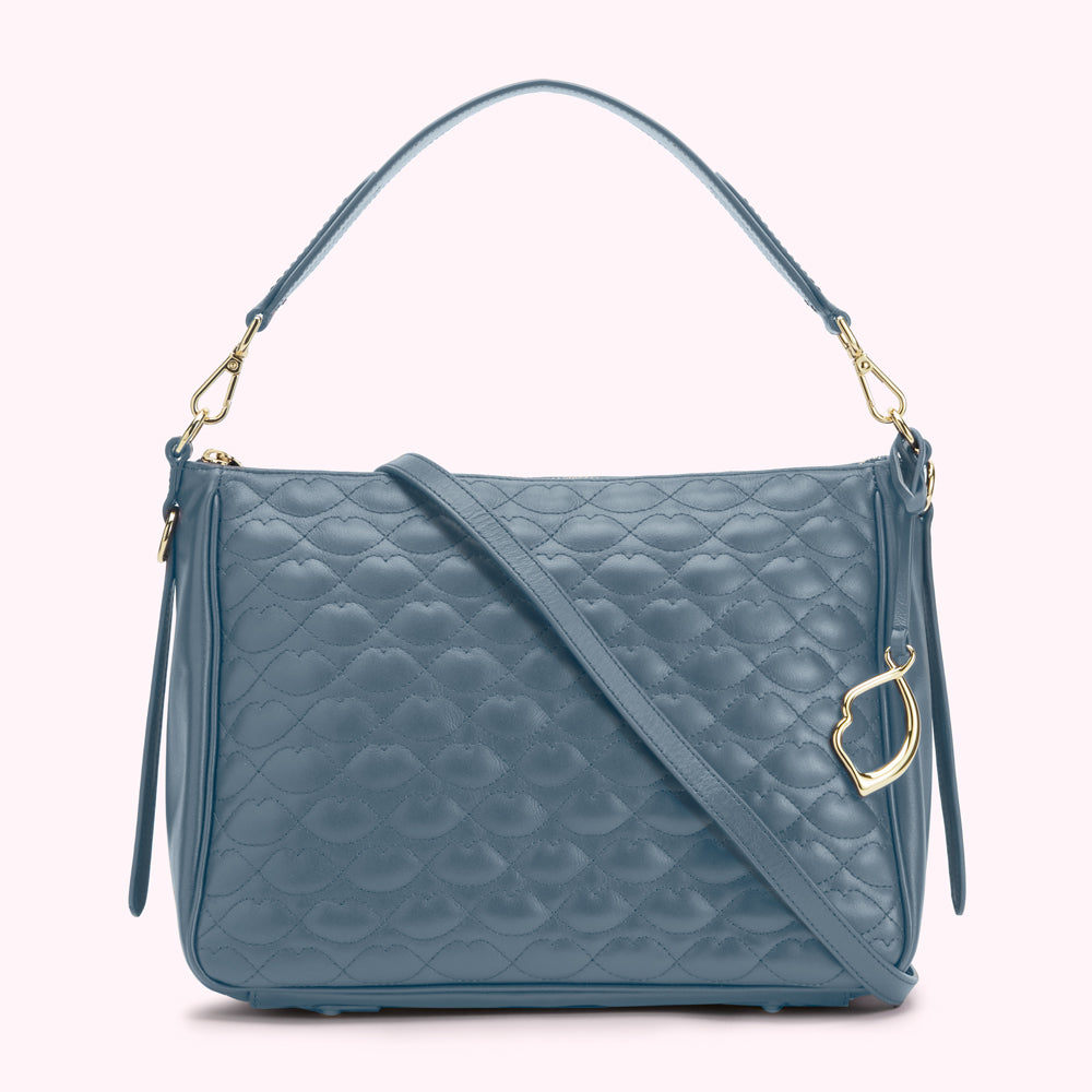 A blue quilted leather handbag with a gold-tone clasp and shoulder strap.
