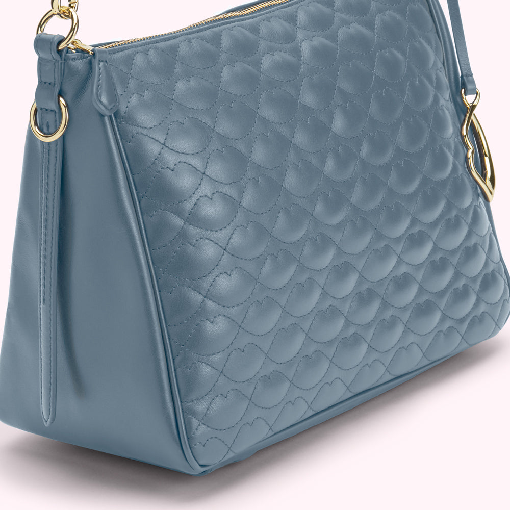 Dusty blue quilted leather handbag with gold-tone hardware.
