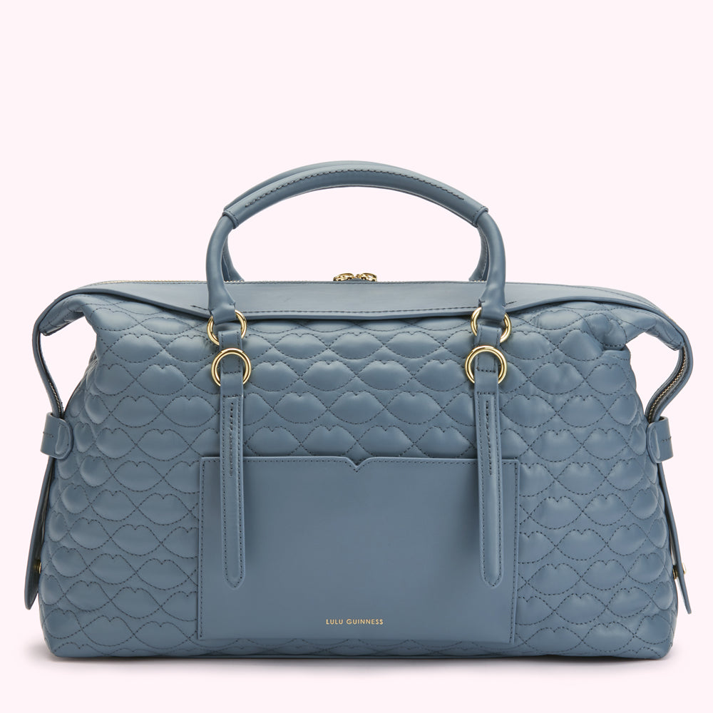 A powder blue quilted Lulu Guinness handbag with gold hardware.