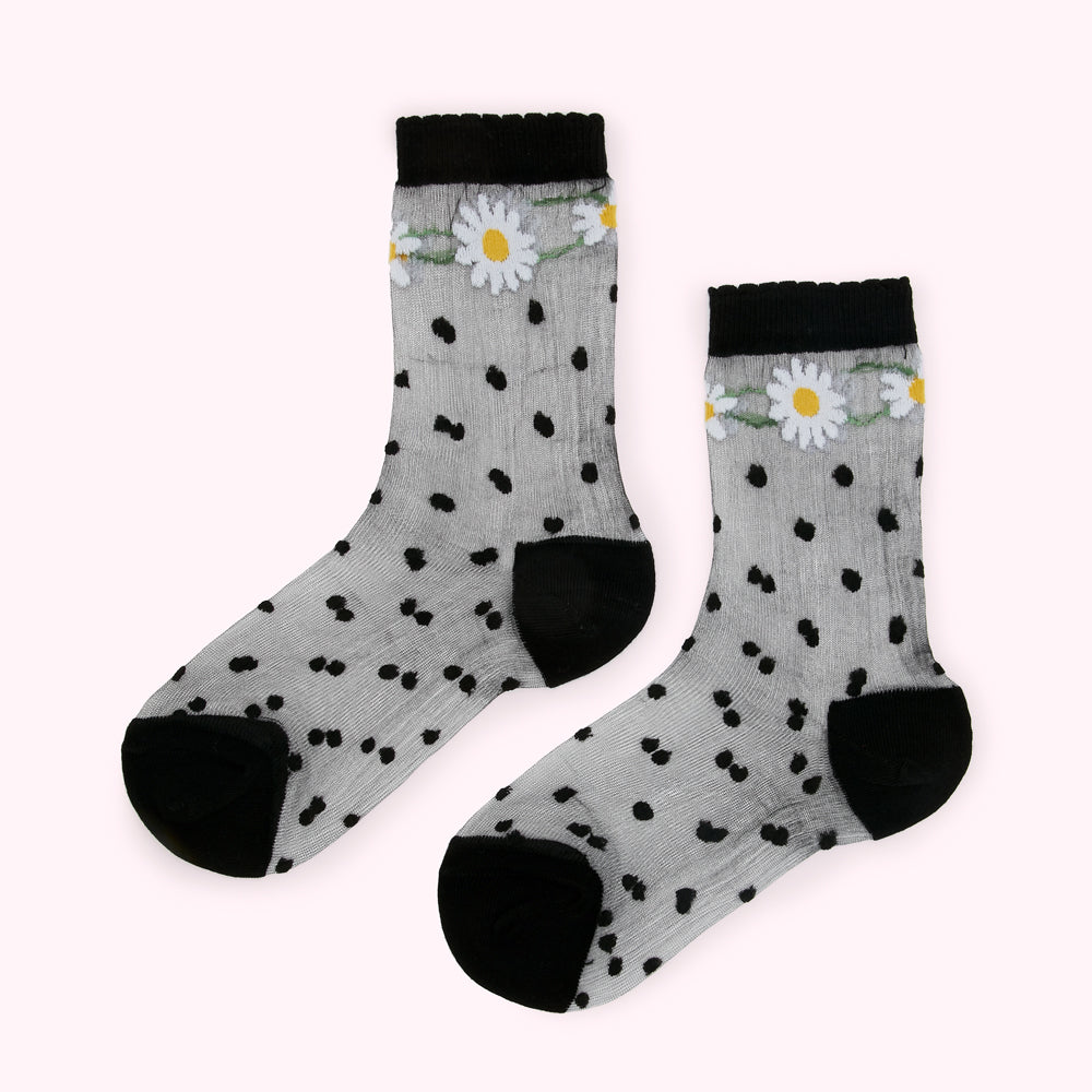 Pair of sheer socks with black polka dots and daisy accents.